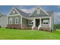 House exterior with brick and green siding at 16 Autumn Breeze Ct, Angier, NC 27501