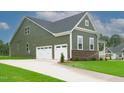 House exterior with two-car garage and landscaping at 16 Autumn Breeze Ct, Angier, NC 27501