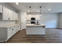 Modern kitchen with white cabinets and island at 156 S Mistflower St, Clayton, NC 27520