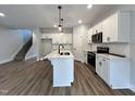 Modern kitchen with white cabinets and island at 156 S Mistflower St, Clayton, NC 27520