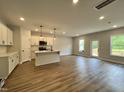 Open living room with hardwood floors and access to patio at 156 S Mistflower St, Clayton, NC 27520