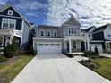 Two story home with gray siding and teal front door at 1220 Porters Call Dr, Wendell, NC 27591