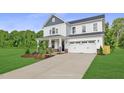 Two-story white house with gray roof, stone accents, and a two-car garage at 81 Eagle Crest Ct # Apex Craftsman, Lillington, NC 27546