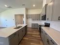Modern kitchen with gray cabinets, quartz countertops and island at 150 Chestnut Oak Ln, Lillington, NC 27546