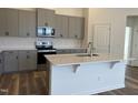 Modern kitchen with gray cabinets, quartz countertops and island at 150 Chestnut Oak Ln, Lillington, NC 27546