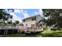 Elevated deck with a swimming pool, propane tank, and surrounding greenery at 1525 Marshburn Rd, Wendell, NC 27591