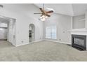 Living room with vaulted ceiling, fireplace and kitchen view at 333 Glenolden Ct, Cary, NC 27513