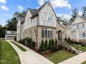 Brick and shingle two-story home with landscaping and driveway at 2646 Marchmont St, Raleigh, NC 27608