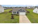 Aerial view of a house with a gray roof and stone accents at 479 Mineral Springs Ln, Fuquay Varina, NC 27526