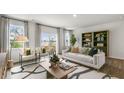 Bright living room with hardwood floors, comfy seating, and large windows offering natural light at 752 Dorset Stream Dr, Fuquay Varina, NC 27526