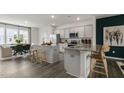 Modern kitchen featuring granite countertops, stainless steel appliances, and an island with seating at 752 Dorset Stream Dr, Fuquay Varina, NC 27526
