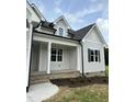 Farmhouse exterior with front porch and landscaping at 0 Will Suitt Rd, Butner, NC 27522