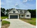 Two-story farmhouse with gray exterior and large driveway at 0 Will Suitt Rd, Butner, NC 27522
