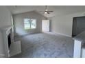 Living room featuring a fireplace, vaulted ceiling and grey carpet at 32 Oakfield Trace Dr, Four Oaks, NC 27524