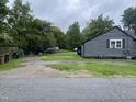 Gray house exterior with a side yard and driveway at 321 Blalock St, Holly Springs, NC 27540