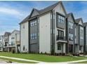 Side view of a contemporary townhome showcasing its gray siding and landscaping at 1140 Cottonsprings Dr, Wendell, NC 27591