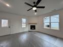 Spacious living room with corner fireplace and large windows at 50 Fetterbush Way, Clayton, NC 27520