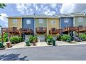 Rear view of townhomes with decks and parking at 128 Dove Cottage Ln, Cary, NC 27519