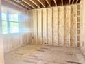 Unfinished bedroom with wood framing, subflooring, and a window at 428 Fast Pitch Ln, Four Oaks, NC 27524