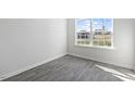 Bright bedroom with grey vinyl plank flooring and a large window at 405 Leven Dr, Gibsonville, NC 27249