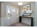 Bright entryway with hardwood floors, white door, and console table at 200 Berry Mill Ln # 153, Raleigh, NC 27603