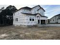 New construction home with gray siding, white trim, and a three-car garage at 536 Barbour Farm Ln, Four Oaks, NC 27524