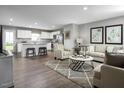 Open-concept living and kitchen area with hardwood floors and stylish decor at 1577 Ivy Meadow Ln, Zebulon, NC 27597