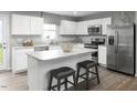 Modern kitchen with white cabinets, stainless steel appliances, and an island at 1577 Ivy Meadow Ln, Zebulon, NC 27597