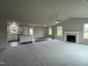 Open floorplan with kitchen island and living area at 83 Oakfield Trace Dr, Four Oaks, NC 27524
