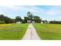Aerial view of farmhouse and long driveway at 8401 Mitchell Mill Rd, Zebulon, NC 27597