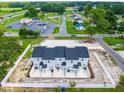 Aerial view showcasing rear of four-unit townhouses and surrounding area at 98 Linda St, Princeton, NC 27569