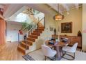 Modern dining area with a round wooden table and white chairs at 103 W Main St # 405, Durham, NC 27701