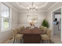 Bright dining room with large table and chandelier at 22 Carlton St, Clayton, NC 27520