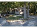 Single story home exterior surrounded by trees at 1612 Us 64, Apex, NC 27523