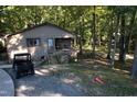 Rustic cabin nestled in wooded lot with ATV at 1612 Us 64, Apex, NC 27523
