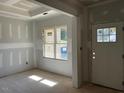 Bright living room with large window and new construction at 42 Yellow Sun Pl, Zebulon, NC 27597