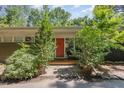 Front entrance with brick walkway and orange door at 9500 Ligon Mill Rd, Wake Forest, NC 27587