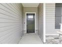 Modern front door with sidelights and stone accents at 129 Colby Farm Dr, Kenly, NC 27542