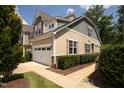Tan and gray two-story townhome with a two-car garage and manicured landscaping at 622 Chronicle Dr, Cary, NC 27513