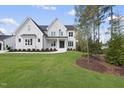 Two story white brick house with landscaping at 2506 Silas Peak Ln, Apex, NC 27523