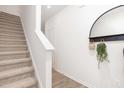Carpeted staircase with white railing and walls at 2833 Egert Dr, Haw River, NC 27258