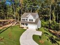Two-story house on a wooded lot with a curved driveway at 900 Sw Maynard Rd, Cary, NC 27511
