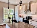 Modern kitchen with stainless steel appliances and granite countertops at 3701 Greystone Dr, Rocky Mount, NC 27804