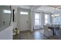 Elegant dining room featuring a large table, chandelier, and hardwood floors at 1841 Old Fields Blvd, Haw River, NC 27258