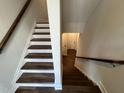 Modern staircase with dark wood treads and white risers at 11549 Helmond Way # 102, Raleigh, NC 27617