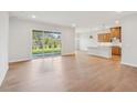 Open concept living room with kitchen and hardwood floors at 208 Regency Ridge Dr, Holly Springs, NC 27540