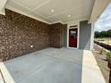 Covered front porch with brick exterior at 324 Village Walk Dr, Clayton, NC 27527