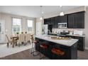 Modern kitchen with island, stainless steel appliances, and dining area at 1218 Helms St, Durham, NC 27713