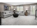 Finished basement with gray sectional sofa and fireplace at 1222 Helms St, Durham, NC 27713