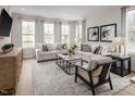 Bright living room with neutral decor, light flooring, and natural light at 1226 Helms St, Durham, NC 27713